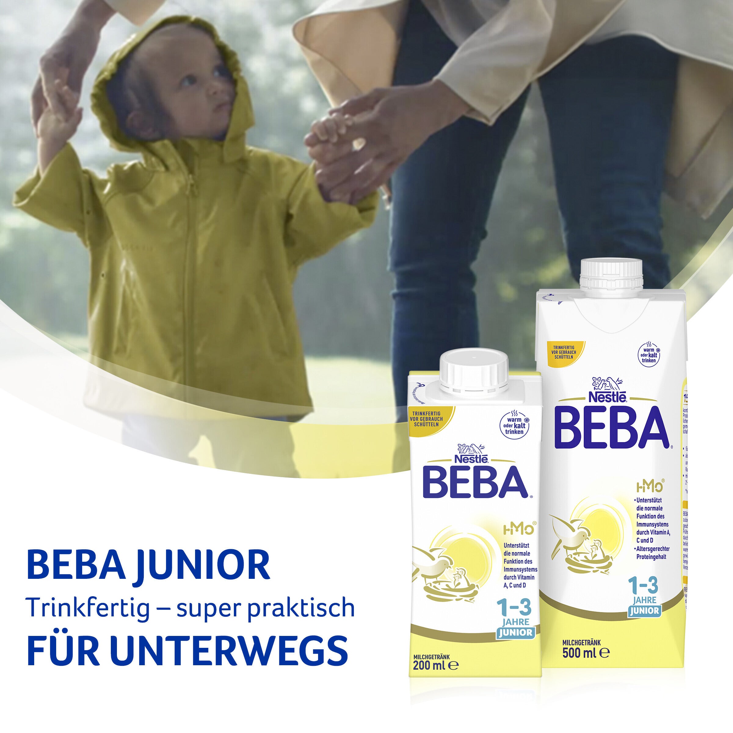Beba Junior milk cartons in foreground, child holding hands in blurred background.