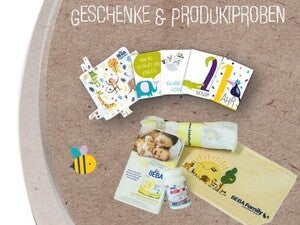Baby care items, a booklet, and a cloth on textured background.