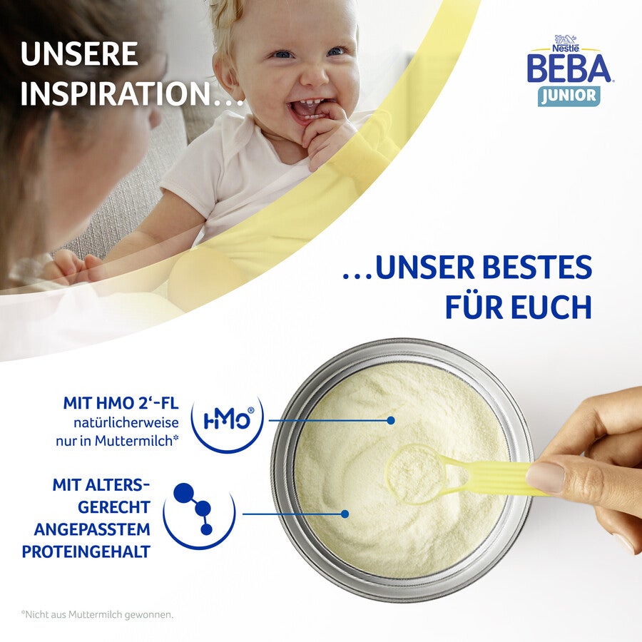 Container of infant formula with a scoop, text overlay, partial view of a child.