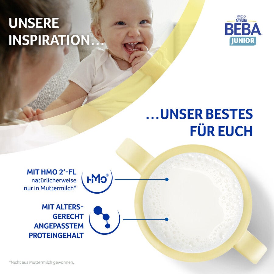 Baby holding bottle of milk with ingredients highlighted.