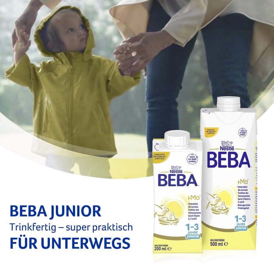 Beba Junior milk cartons in foreground, child holding hands in blurred background.
