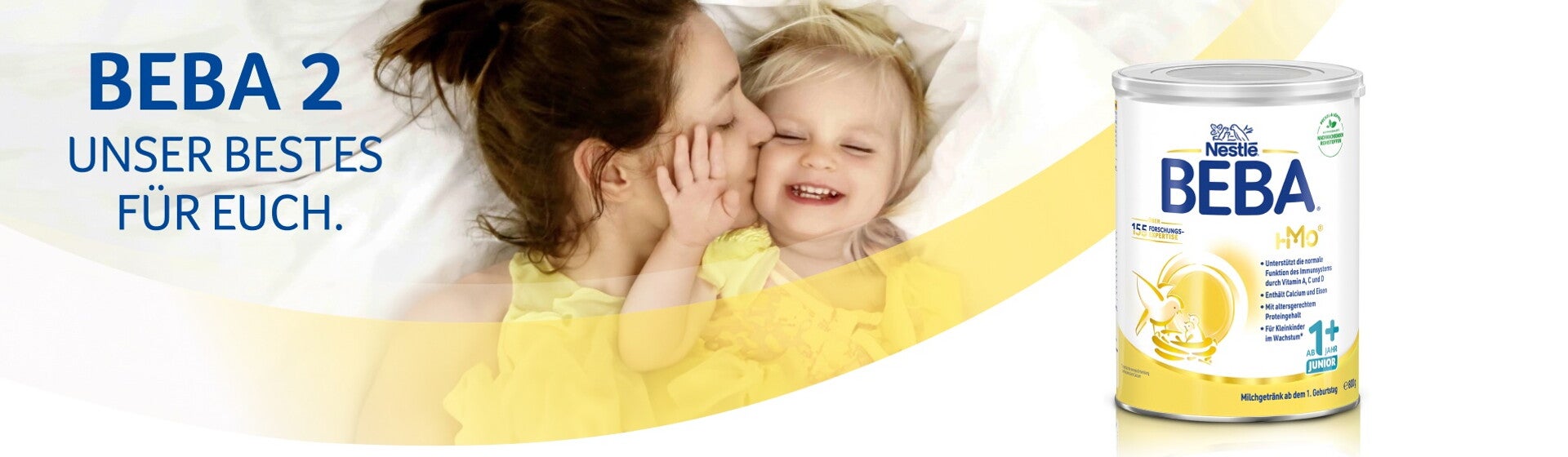 BEBA JUNIOR Kindergetränk – Mutter küsst ihr lachendes Kind BEBA JUNIOR Kindergetränk – Mutter küsst ihr lachendes Kind