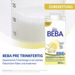 Container and measuring cup with Beba Pre baby milk formula, yellow accent.